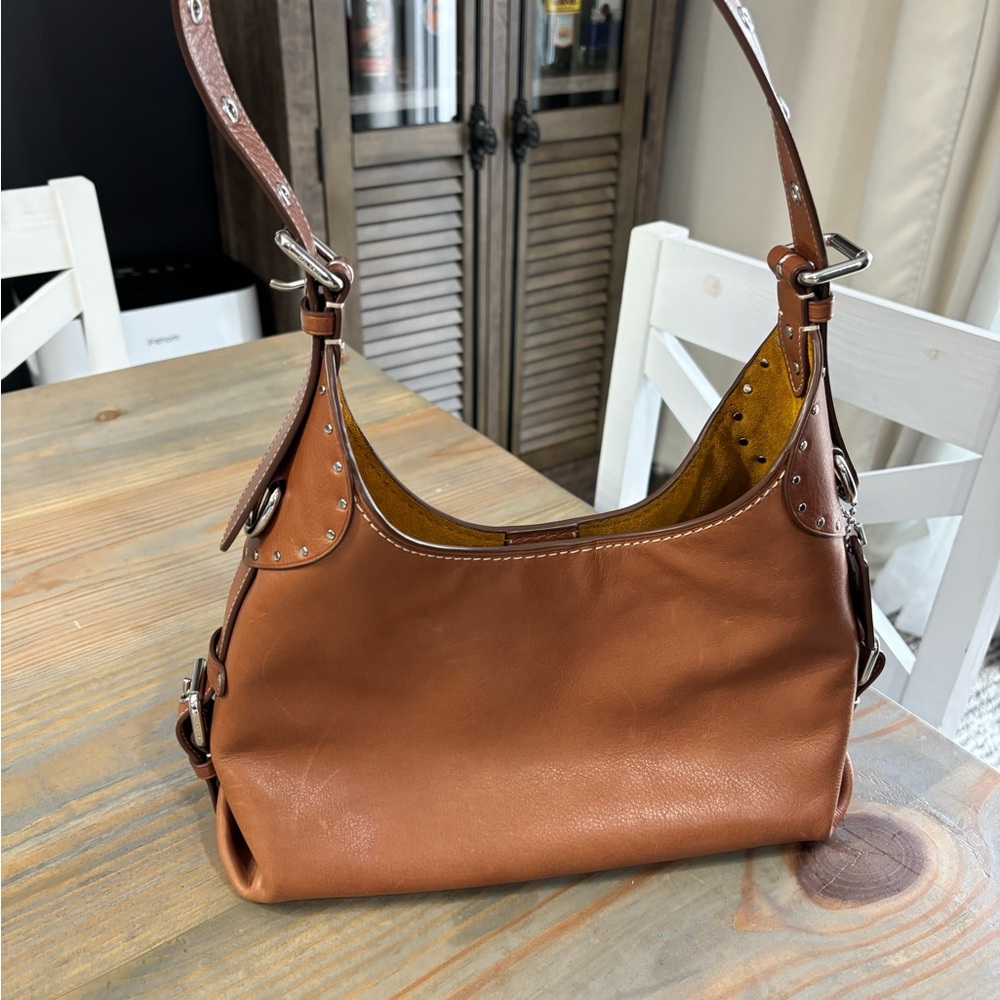 Coach Brown Leather Shoulder Bag with Curved Shape and Luxurious Texture